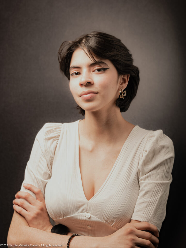 beautiful lady with short hair and wearing white shirt, posing and smiling to the camera camera