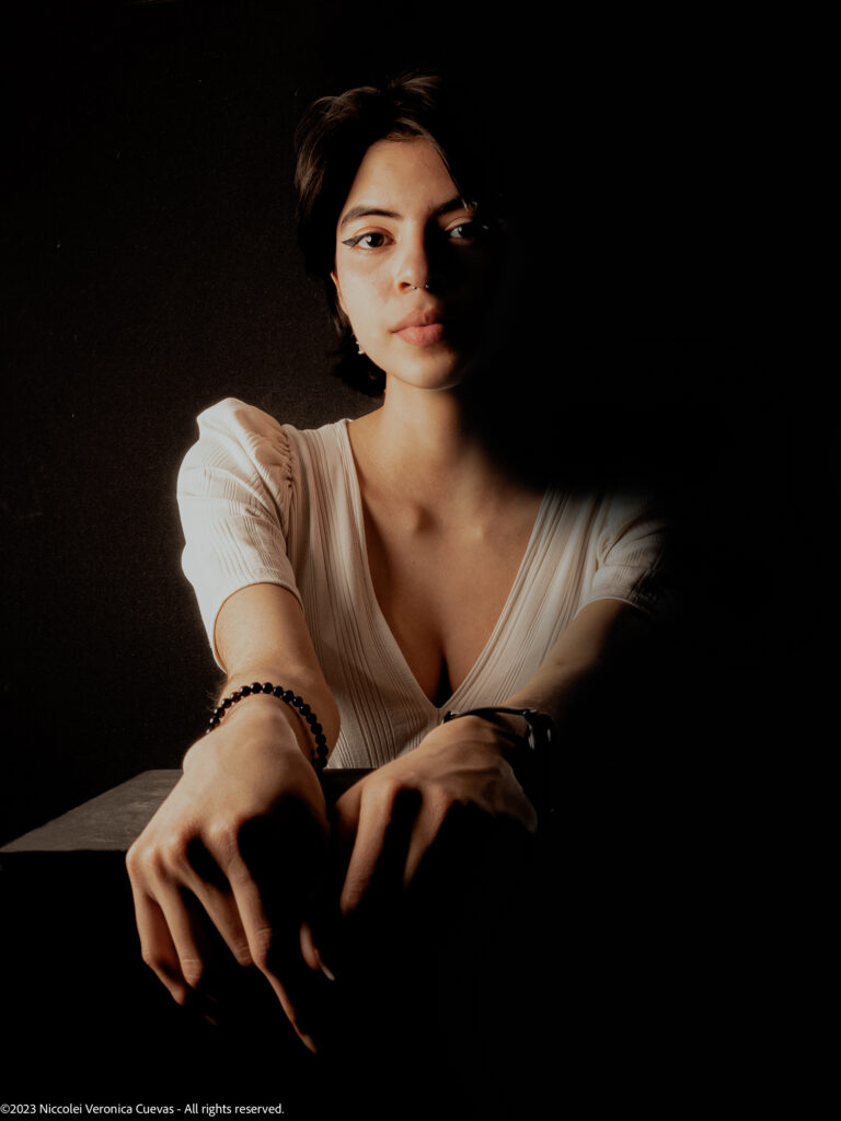 beautiful lady with short hair and wearing white shirt, posing fiercely to the camera camera