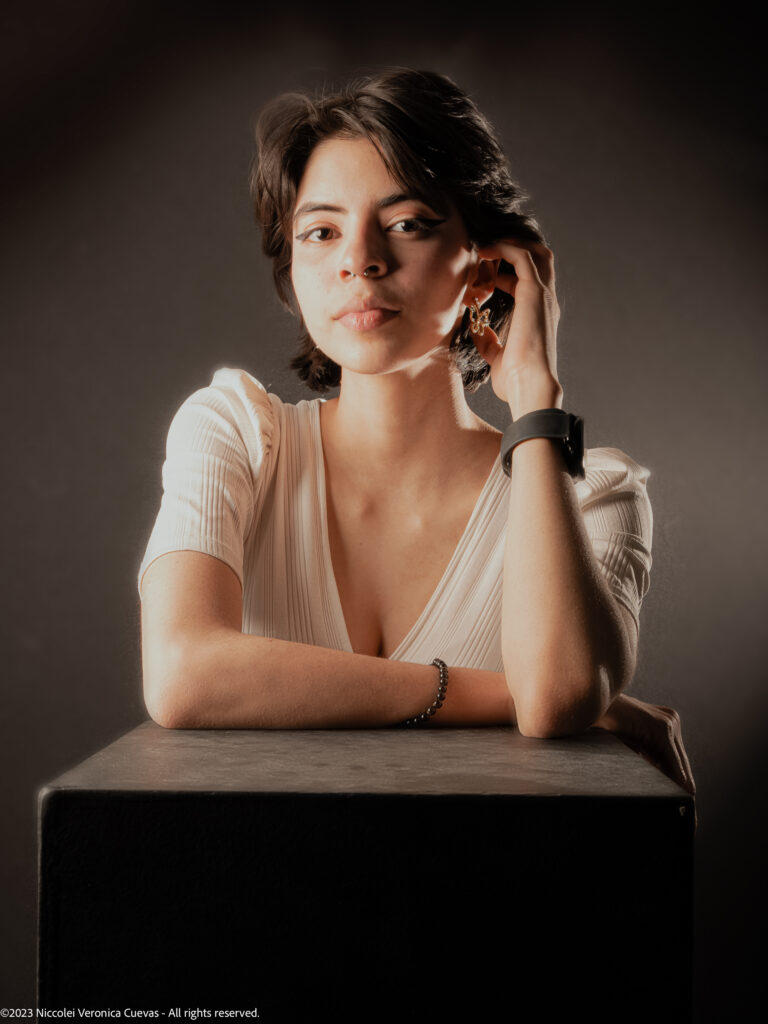 beautiful lady with short hair and wearing white shirt, posing fiercely to the camera camera